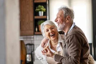 Happy senior couple having fun in the kitchen