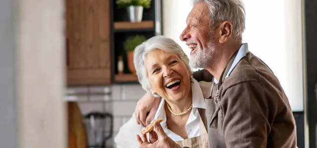 Happy senior couple having fun in the kitchen